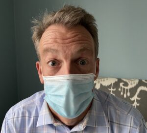 listening to surprised person wearing a mask