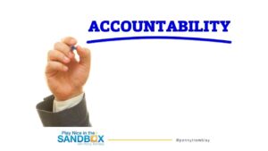 image of hand writing on a board "Accountability" in blue to hold people accountable