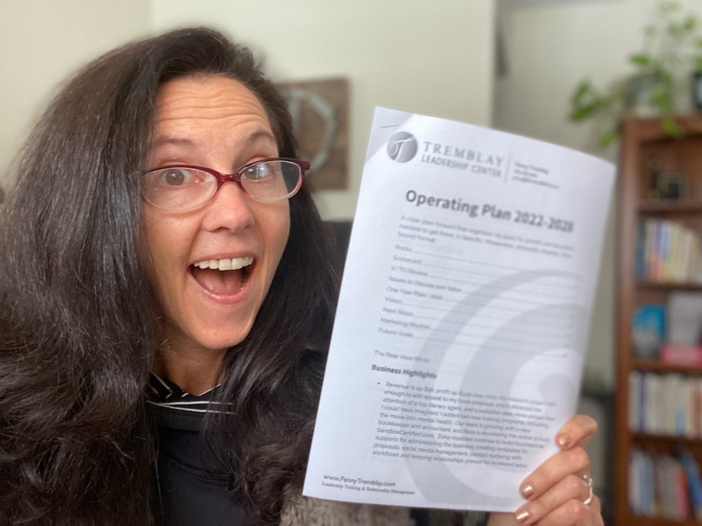 image of Penny Tremblay holding her business plan for 2022
