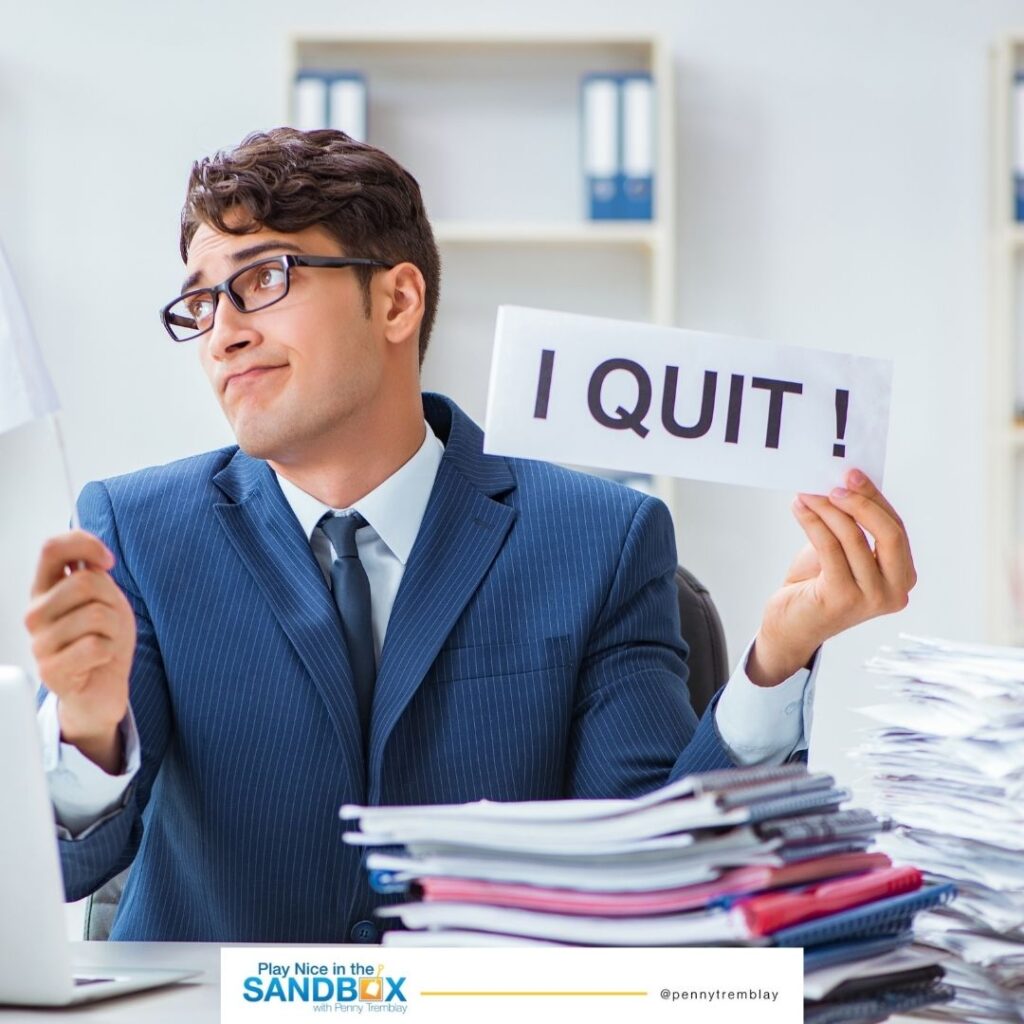 image of a man holding a sign that says I QUIT! lacking employee engagement