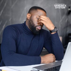 a stressed man looking at his laptop