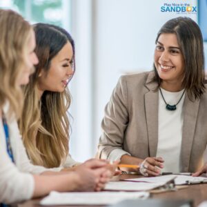 image of 3 women sitting at a table where they are practicing the art of active listening