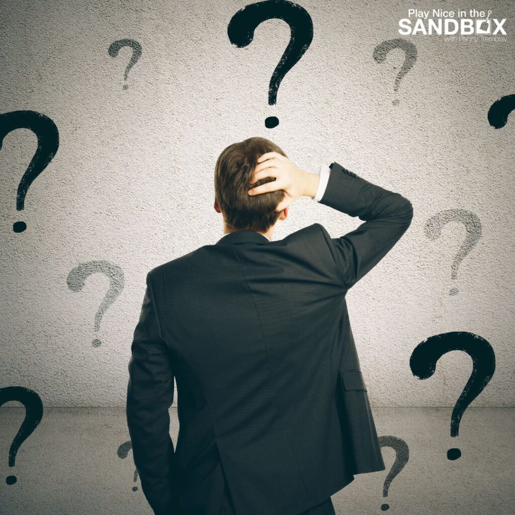 image of the back of a man in front of a wall covered in question marks to show communication