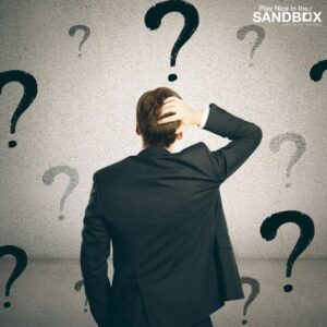 image of the back of a man in front of a wall covered in question marks to show communication