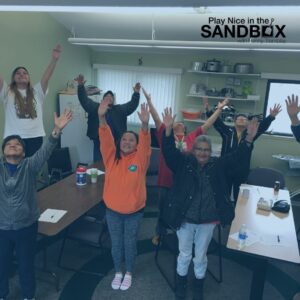 image of a group of Penny's students with their hands in the air to signify Transforming Workplace Conflict into Opportunity