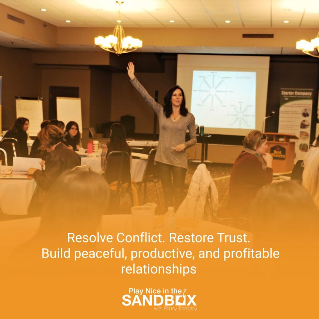 image of Penny Tremblay in a room of people that she is working with and text that says restore conflict, restore trust, build peaceful, productive and profitable relationships to show The Hidden Cost of Avoiding Conflict