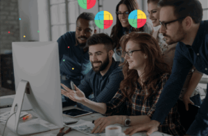 image of a group of people sitting together looking at a computer screen and symbols above their heads to show Whole Brain® Thinking