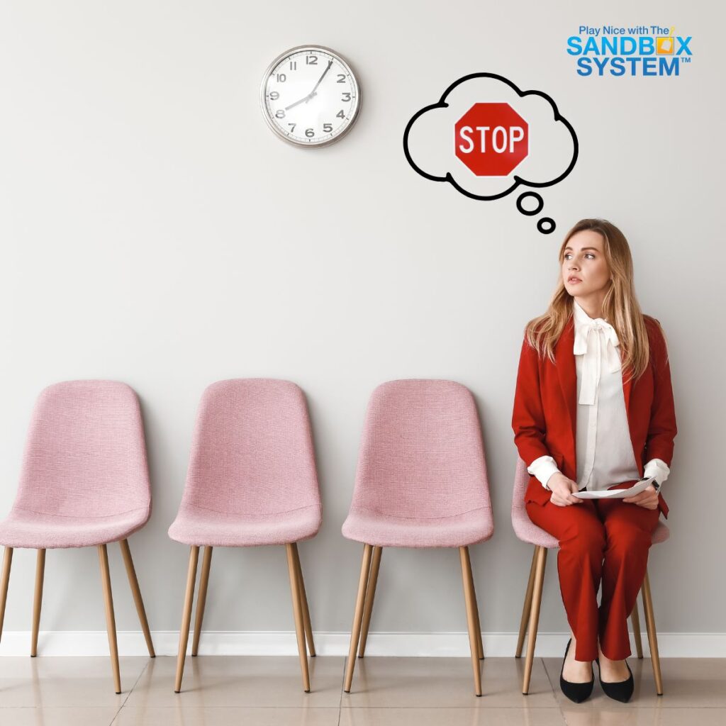 image of a woman sitting in a chair waiting to go into speak to her boss with a thought bubble over her head with a stop sign in it to show Why “Open Door” Policies Aren’t Enough