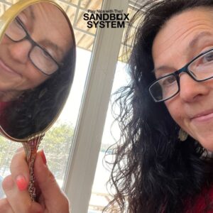 image of Penny Tremblay looking in a mirror to show how The Resume and The Mirror can both reflect