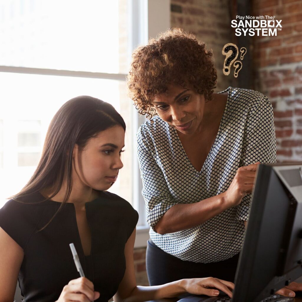 image of a woman standing and another woman sitting at a desk to show The Most Powerful Question a Manager Can Ask